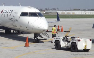 a man walking next to an airplane