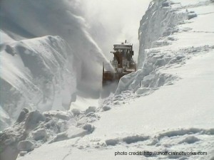 a snow plow clearing a mountain