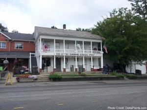 a building with a porch and a flag