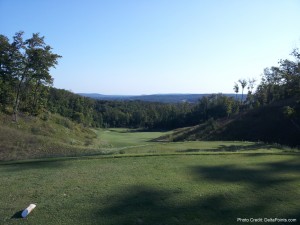 a golf course with trees and hills