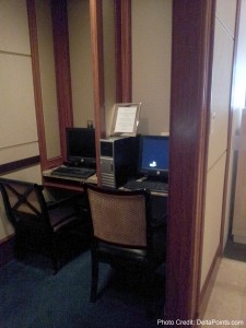 a computer desk with two computers
