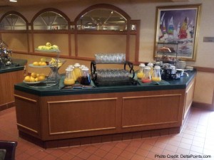 a buffet table with fruit and juice
