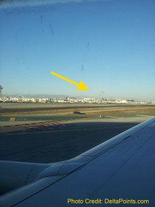 an airplane wing with a yellow arrow pointing to the sky