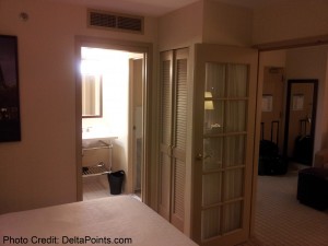 a bedroom with a door and a mirror