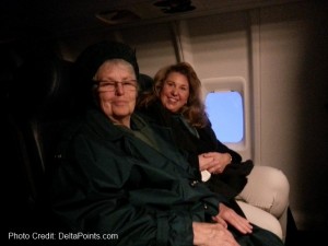 a couple of women sitting in a plane
