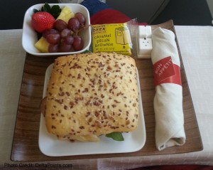 a sandwich and fruit on a tray