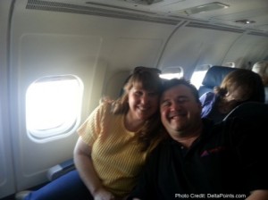 a man and woman sitting on an airplane