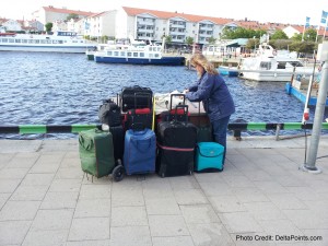 a woman standing next to a row of luggage