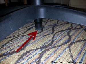 a red arrow pointing to a chair leg