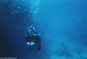 a person underwater with a scuba diver