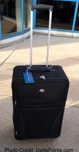 a black suitcase with a blue tag