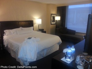 a hotel room with a bed and a coffee table