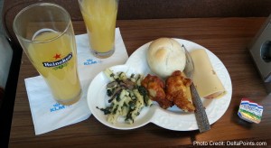 a plate of food and a glass of juice