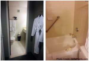 a bathroom with bathrobes and bathtub