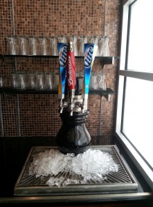 a black beer tap with ice on a table