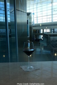 a glass of red wine centurion lounge delta points review